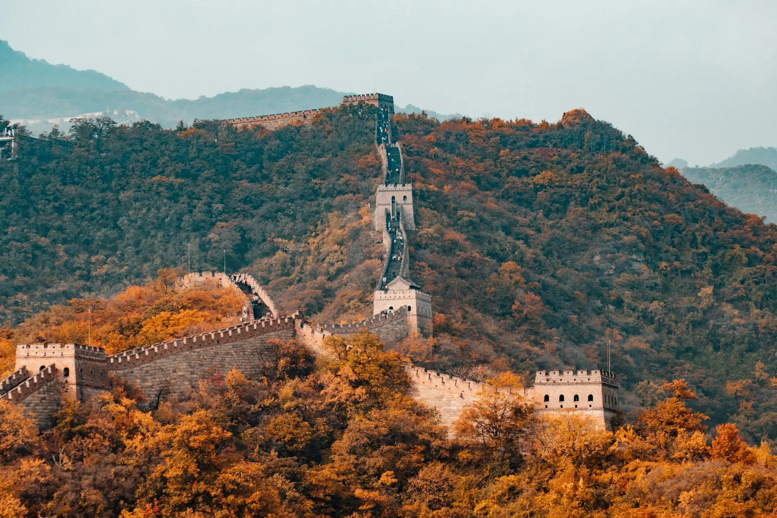 The Great Wall of China running along autumn hillsides.